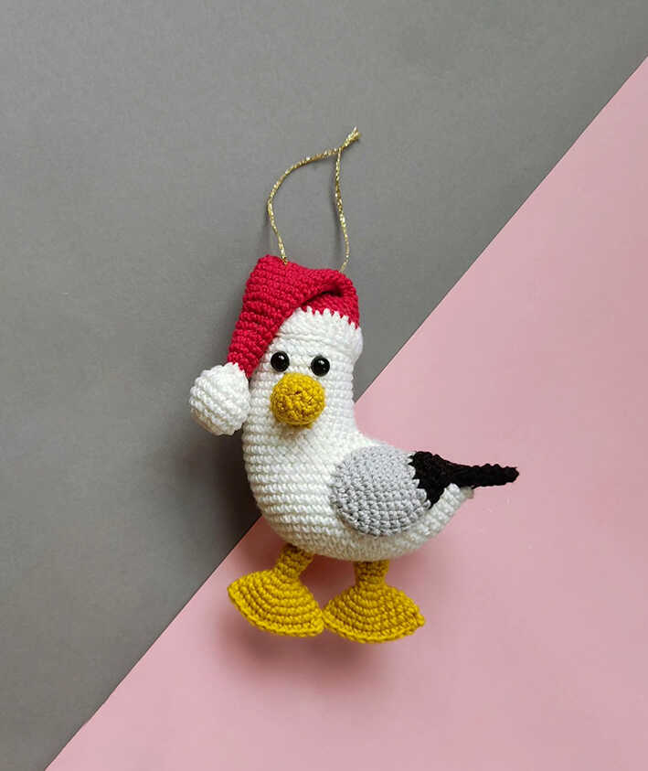 This is a high-quality image of the completed Christmas seagull from our free amigurumi pattern.