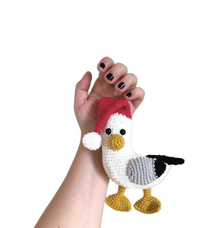 This is a professional image of the Santa Seagull amigurumi from our free crochet pattern.